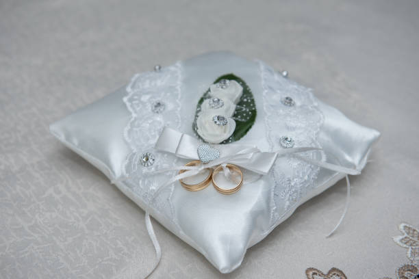 istock 10K Gold Engagement-Wedding Ring Set on a White Pillow 1767015674