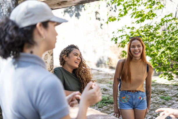 istock Tour guide and young adults chatting in historic old building 1767016259