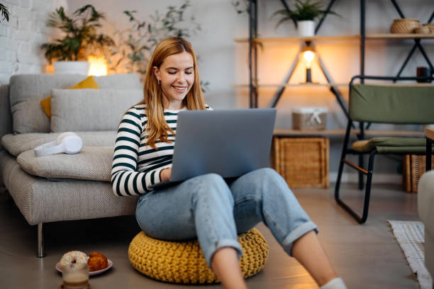 istock Young woman using a laptop at home 1767025873