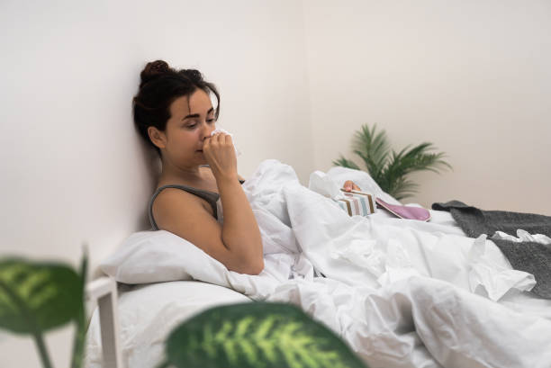 istock Battling illness, she sits in bed, using tissues and medical drops to alleviate her symptoms 1767031483