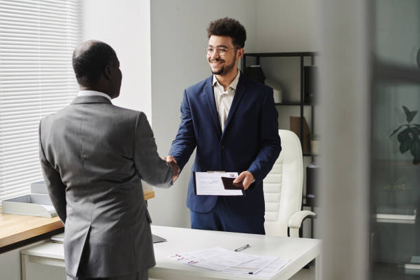 istock Specialist congratulating man of getting visa 1767032601