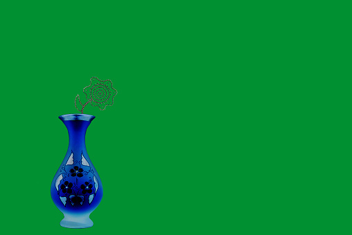 Vase with a flower on a green background.