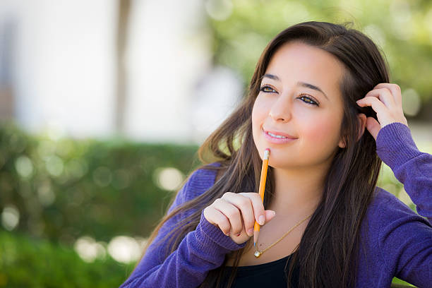istock Pensive Mixed Race Female Student with Pencil on Campus 176704369