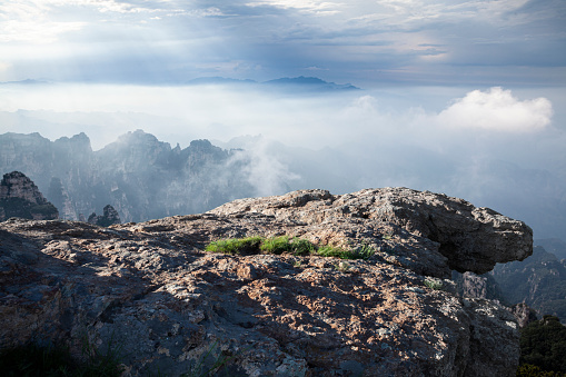 Big rocks on top of mountains, and foggy skies