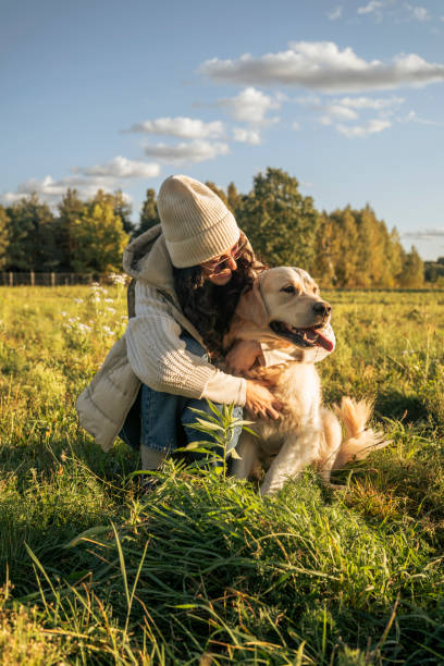 istock Woman walking a dog on a leash. Hugging the dog 1767052349