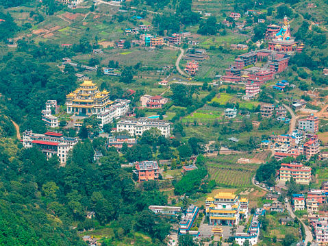 Aerial view of Kathmandu valley, temple on the hills. The monastery is surrounded by lush green hills. 10-10-2023. Rinpoche Statue, Asura Cave, Old Dashinkali Temple, Pharphing. Nepal