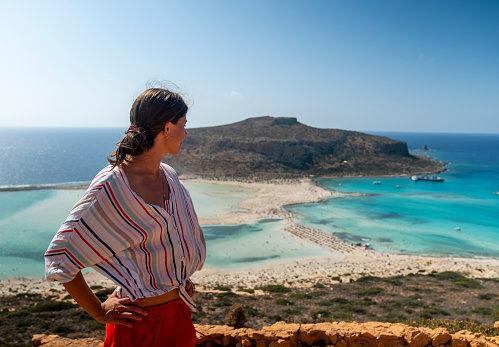 Summer vacations in the hot Greece on Crete island. Sightseeing trip across a beach with turquoise sea