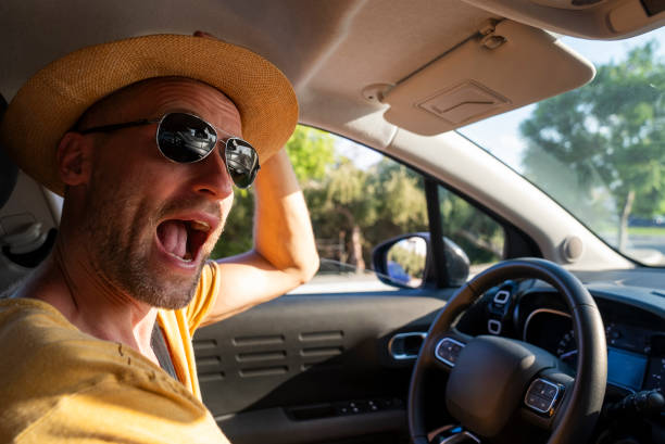 istock Man driving a car. Yelling with excitement. 1767066619