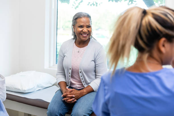 istock Mature female patient smiles while the nurse talks 1767067806