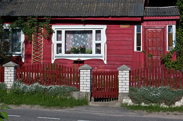 istock Front of red wooden house with white window 176707385