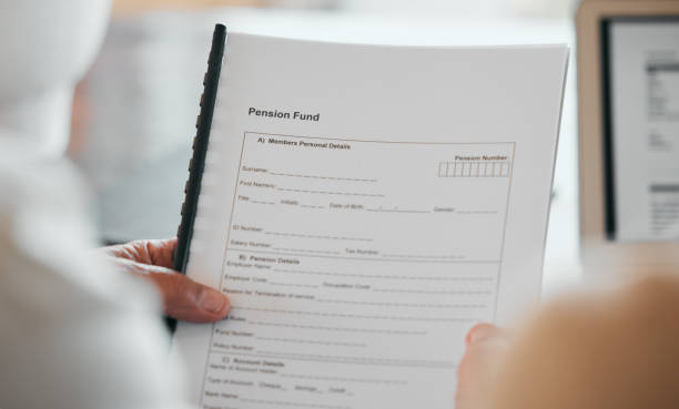 istock Person, hands and documents for pension fund, application or paperwork in retirement at home. Closeup of elderly or retired form, contract or plan for old age allowance, funding or insurance in house 1767093725