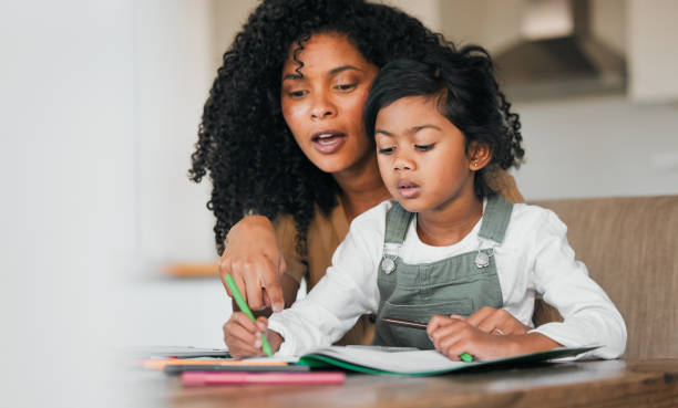 istock Writing, home school and parent help child learning or study an assessment in education with laptop together. Development, online and mother teaching kid with knowledge for support in numbers project 1767093736