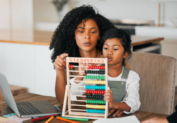 istock Math, home school and parent help child learning or study an assessment in education with laptop together. Development, online and mother teaching kid with knowledge for support in numbers project 1767093741
