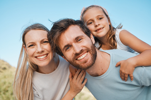 Nature portrait, happiness and family child, mother and father enjoy time together, park or outdoor wellness. Freedom, summer holiday and face of happy mom, dad and young kid bonding, care and love