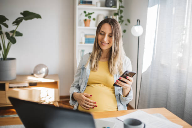 istock Pregnant woman working at home office. 1767094372