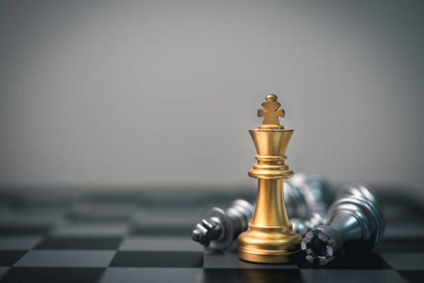 istock King chess stands tall amid fallen pieces, symbolizing leadership, teamwork, and victory over competition. 1767096064