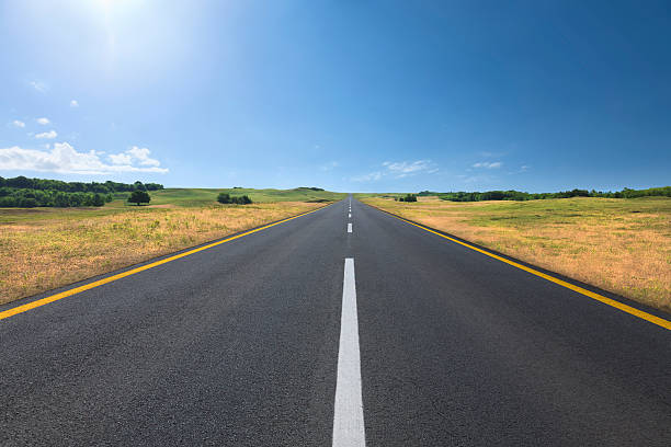 istock Driving on an empty road at bright sunny day 176709850