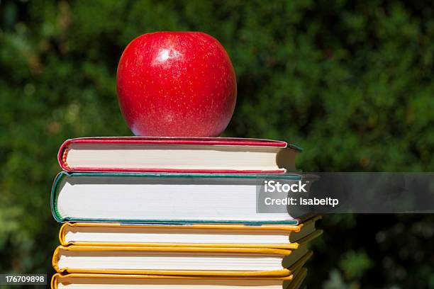 Bright Red Apple On The Top Stock Photo - Download Image Now - Apple - Fruit, Blue, Book