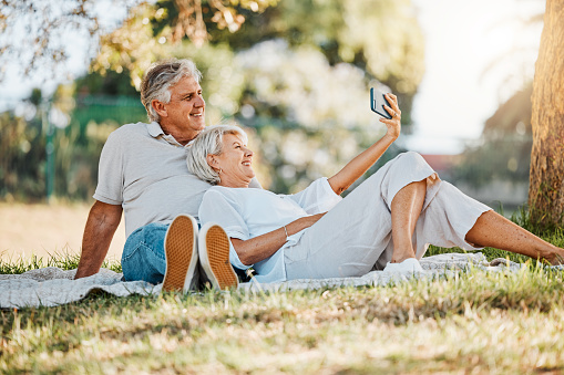 Picnic, selfie and senior couple with love, relax and connection with social media, retirement and marriage. Romance, outdoor and old woman with elderly man, digital app and relationship with bonding