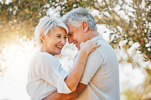 Senior happy couple, laughing or hug in nature garden for love, support or bonding retirement trust. Woman smile, relax or elderly man in embrace for relationship, connection and together in backyard