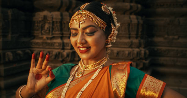 istock Close-Up of an Indian Female Dancer Displaying Symbolic Gesture with Expressive Face, Using Folkloric Dance to Tell a Story. Girl in Traditional Sari Showcasing the Art of Mudras Movement 1767113082