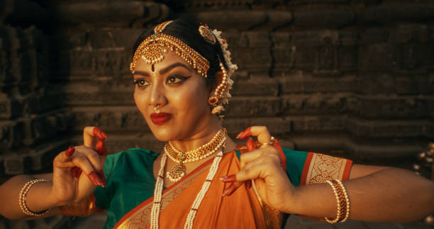 Close-Up of an Indian Female Dancer Displaying Symbolic Gesture with Expressive Face, Using Folkloric Dance to Tell a Story. Girl in Traditional Sari Showcasing the Art of Mudras Movement