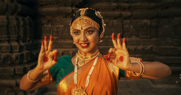 istock Close-Up of an Indian Female Dancer Displaying Symbolic Gesture with Expressive Face, Using Folkloric Dance to Tell a Story. Girl in Traditional Sari Showcasing the Art of Mudras Movement 1767113138