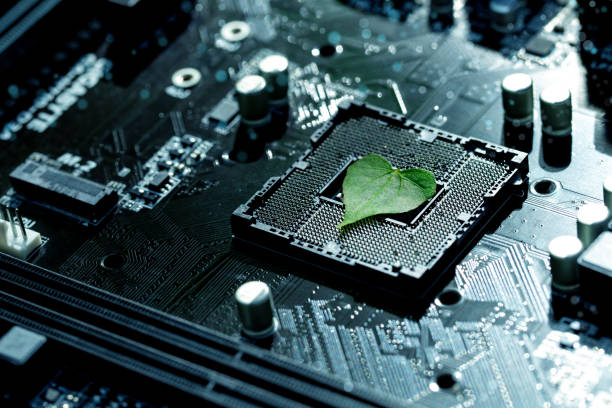 istock Heart shaped green leaf inside a Computer Circuit Board. Green technology and Environmental technology. Green Computing, CSR, IT ethics.Nature with Digital Convergence and Technological Convergence. 1767113300