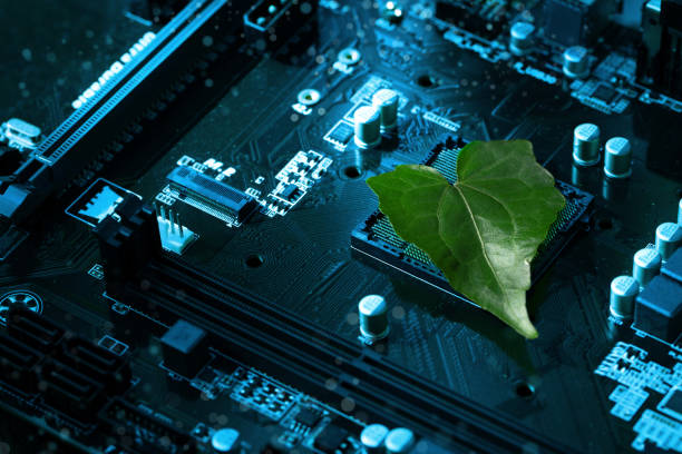 Heart shaped green leaf inside a Computer Circuit Board. Green technology and Environmental technology. Green Computing, CSR, IT ethics.Nature with Digital Convergence and Technological Convergence.