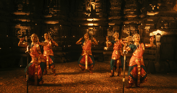 Enchanting Slow-Motion Portrayal Showcases a Lively Ensemble of Indian Women Joyfully Dancing Traditional Folk Inside an Empty Historic Temple. Vibrant and Mesmerizing South Asian Cultural Festivity