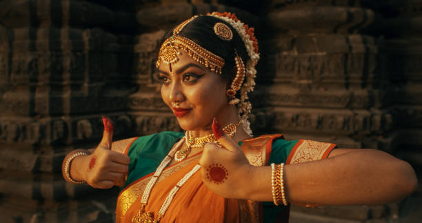 istock Portrait of an Indian Female Dancer Displaying Symbolic Gesture with Expressive Face, Using Folkloric Dance to Tell a Story. Girl in Traditional Sari Showcasing the Art of Mudras Movement 1767114468