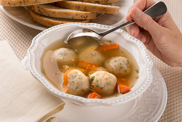 Bowl of matzah ball soup, a traditional Jewish Passover dish stock photo