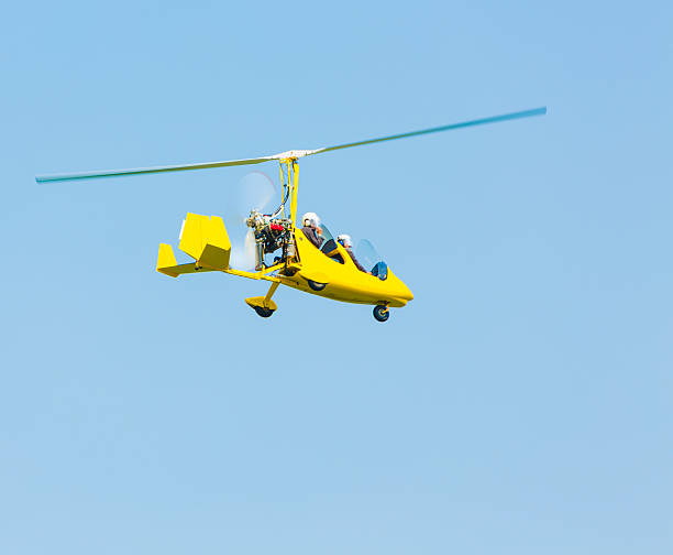 Autogiro flying Autogiro flying against clear blue sky. ultralight stock pictures, royalty-free photos & images