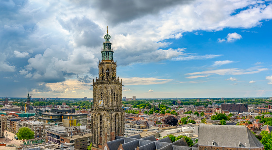Panoramic view over the Martinitoren tower in the city of Groningen in The Netherlands from the Forum cultural center with a dramatic sky above.