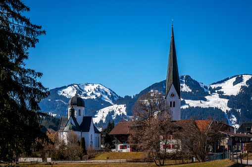 Beautiful panoramic view of historic Gosau mountain village on a scenic cold sunny day with blue sky and clouds in winter, Salzkammergut, Upper Austria region, Austria
