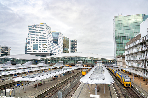 Station Utrecht Centraal, Utrecht Centraal railway station with trains arriving and departing. Utrecht central station is the biggest train station in the Netherlands, because of its central location in the Netherlands, Utrecht Centraal is the most important railway hub in Holland.