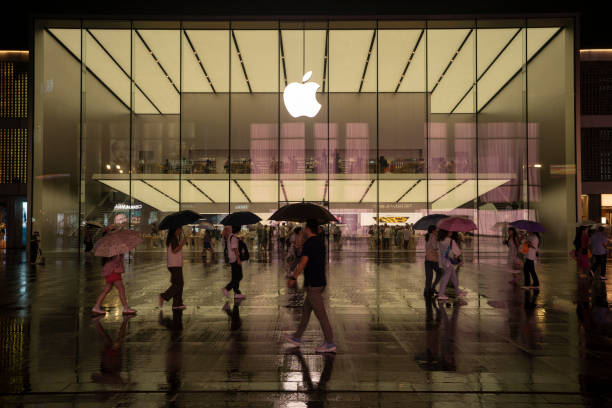 Chongqing, China - August 6, 2024. The striking glass cylindrical entrance of the Apple Store in Jiefangbei CBD, Chongqing, China, stands tall amidst modern skyscrapers, showcasing the seamless blend of architecture and technology in one of Chinas most bustling commercial districts.