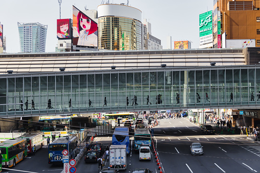 Tokyo, Japan - April 11, 2023: pedestrian skywalk in Shibuya, with unidentified people. Shibuya is a major commercial and finance center