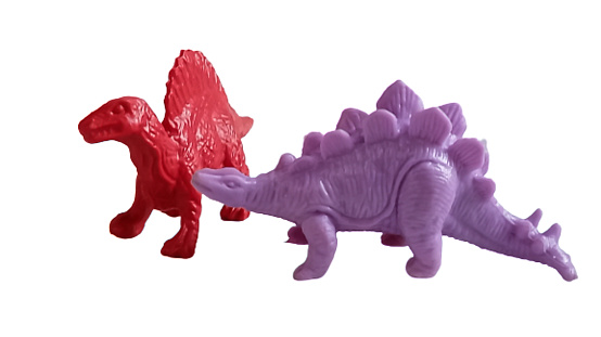 a group of Toy dinosaurs on a white background