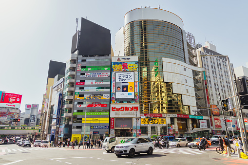 Tokyo, Japan - April 11, 2023: intersection with commercial buildings with unidentified people in Shibuya. Shibuya is a major commercial and finance center