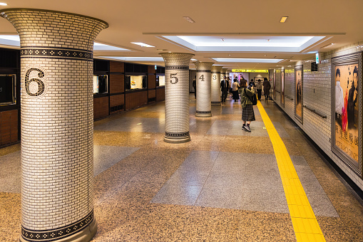 Tokyo, Japan - April 10, 2023: underpass of an underground station in Ginza district with unidentified people. Ginza is one of the most famous commercial districts even in the world