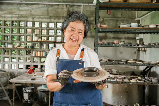 Experience well-being through art therapy as senior women find contentment in retirement. This portrait showcases the therapeutic joy of creative expression