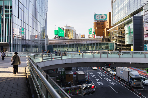Tokyo, Japan - April 11, 2023: pedestrian overpasses in Shibuya, with unidentified people. Shibuya is a major commercial and finance center