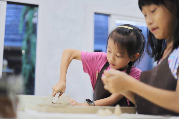 istock Two girls kneading clay in the pottery classroom 1767170260