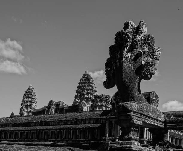 Multi headed snake statue and towers of Ankor Wat, Cambodia.