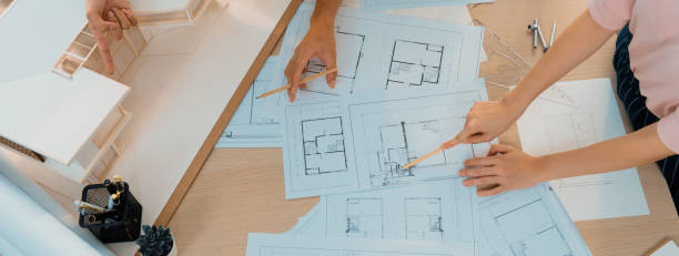 istock Skilled engineer team meeting presents house construction. Top view. Burgeoning. 1767180063