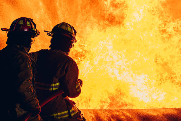 istock Firefighter Concept. Fireman using water and extinguisher to fighting with fire flame. firefighters fighting a fire with a hose and water during a firefighting training exercise 1767183261
