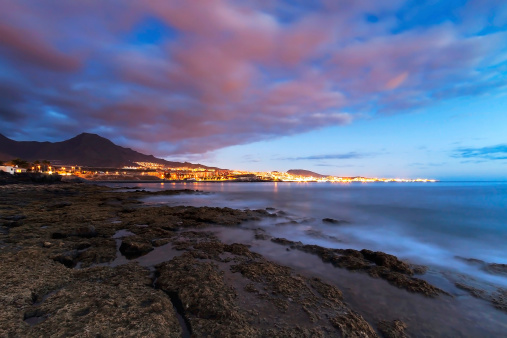 Night view of Costa Adeje in South Tenerife with the tourist resorts from La Caleta through Playa del Duque, Fanabe, Torviscas to Playa de las Americas in the background.
