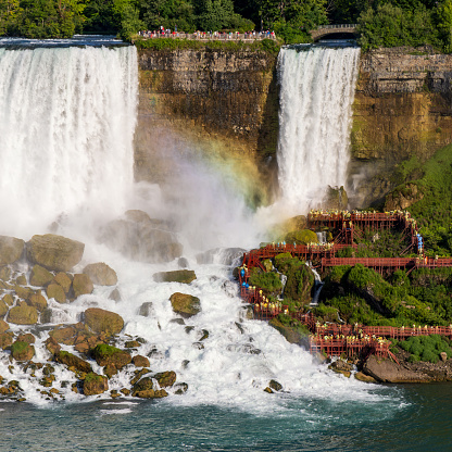 Square photo of Luna Island with the Bridal Veil Falls  on the right and American Falls on the left and a partial rainbow, Niagara Falls, USA