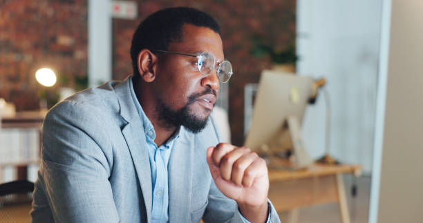 istock Startup, night and black man in office, online reading and computer for data analysis, website and information. Employee, consultant and African agent in workplace and email check on pc for overtime 1767192929